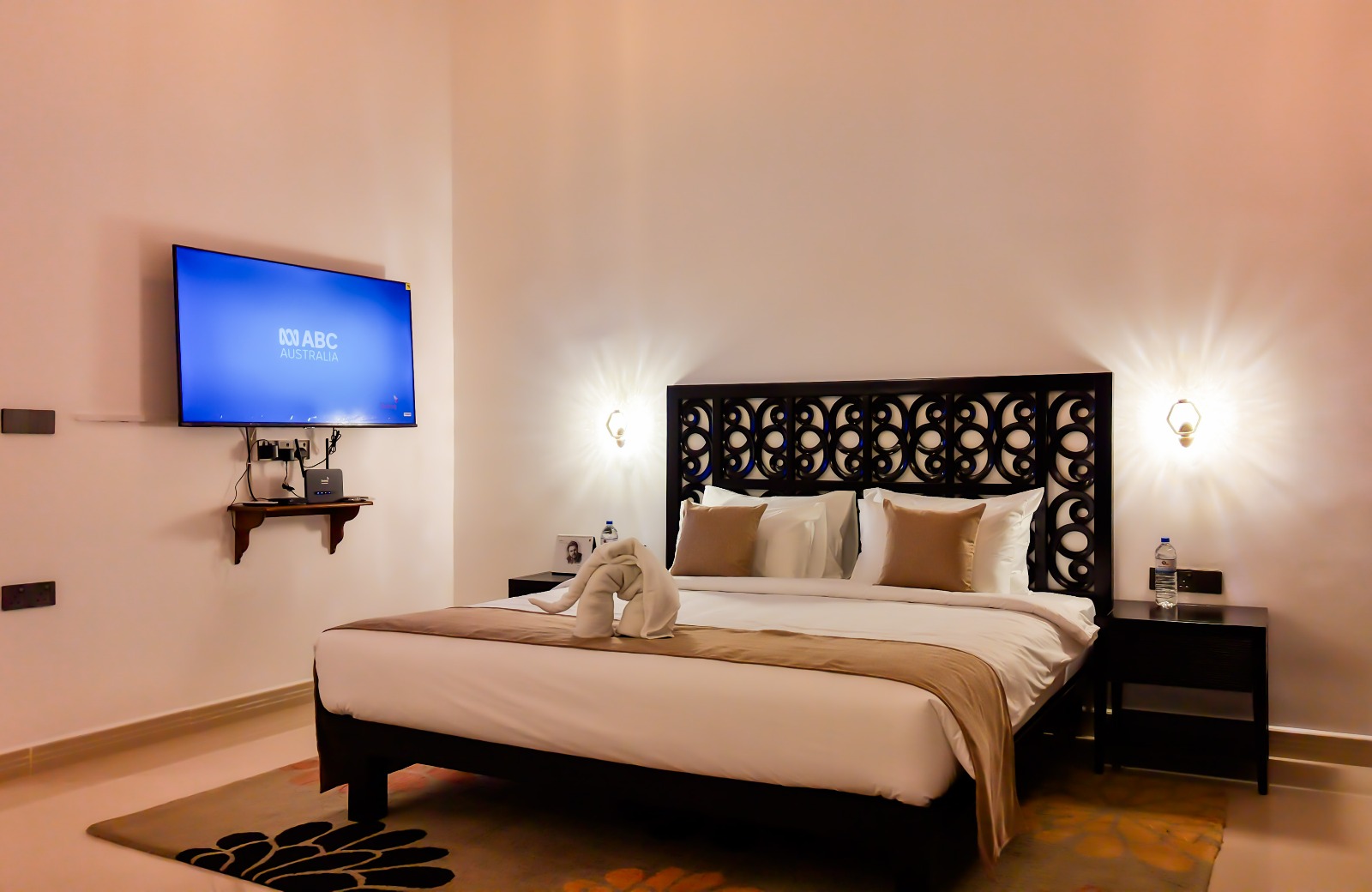 Comfortable double bedroom with TV and warm lighting
