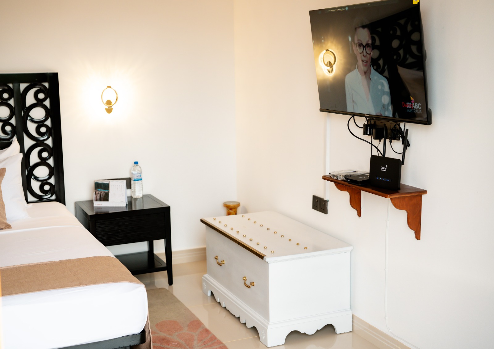 Room interior with TV, bedside table and storage chest