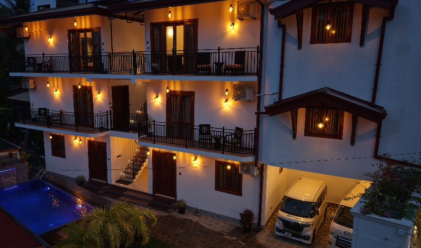 Seven Moon Villa at night with lit balconies and pool